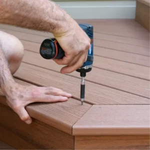 Hand holding drill while building a deck