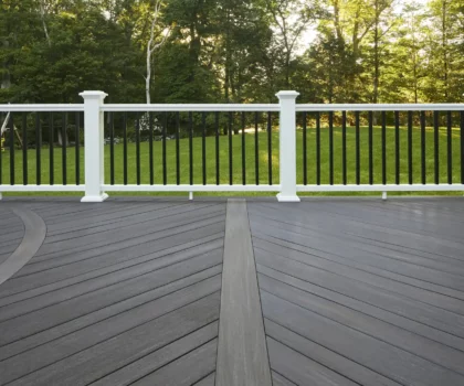 White deck railing, dark balusters, and dark gray decking