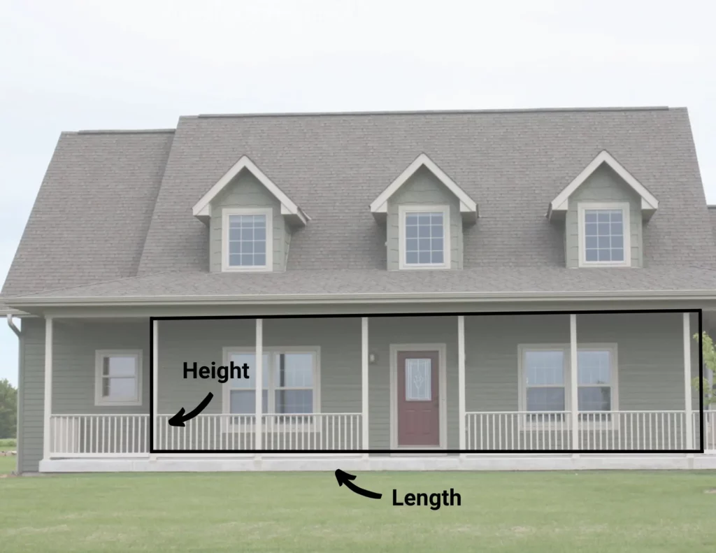 How to measure exterior siding: Front of a 2-story home with a porch and railing. The porch is outlined up to the roof line into a rectangle. Arrows point to the height and length of the rectangle.