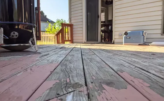 Closeup of wooden deck needing cleaning and staining. Composite decking is easier to clean than wood decks