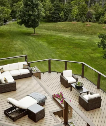 Deck ideas: Multi-level tan deck with matching planters where the level changes