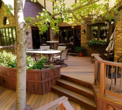 Composite Deck Ideas: Multi-level brown deck with large built-in planter next to stairs