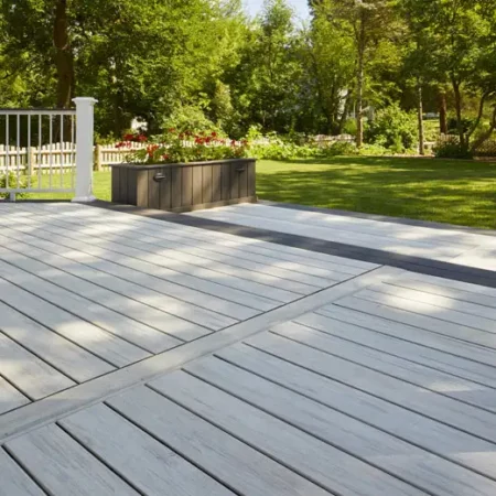 Deck ideas: Gray decking with large brown planter made from fascia next to deck