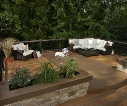 Deck designer: Bricked built-in planter used to create a separate space on a large deck with seating