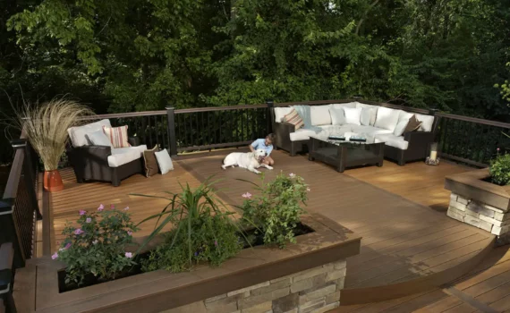 Deck designer: Bricked built-in planter used to create a separate space on a large deck with seating