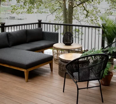 a waterfront deck under the shade of a tree