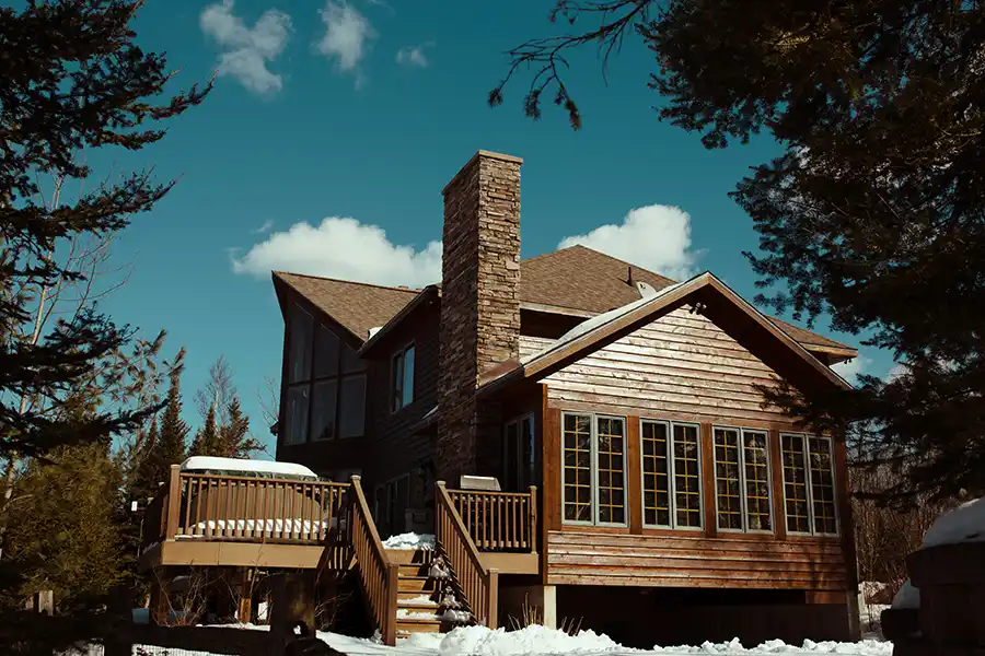 A home and deck in the winter with snow