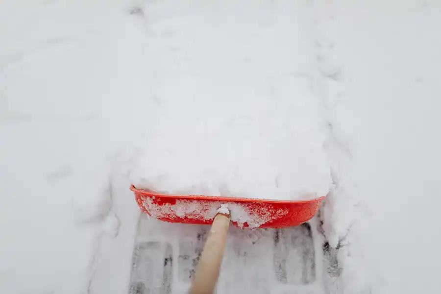 Removing snow with a plastic shovel