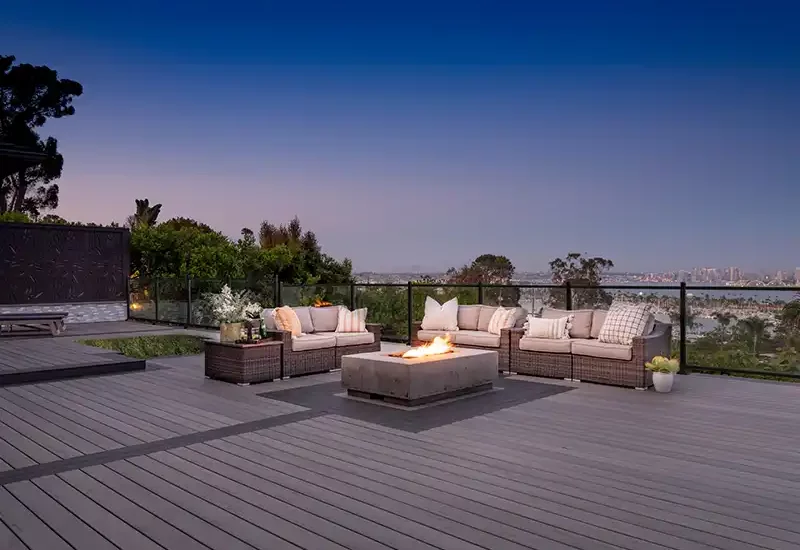 A large, beautiful deck at dusk with long deck railing
