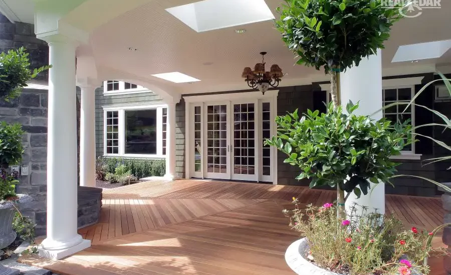 An expansive covered cedar deck with large planter in the foreground