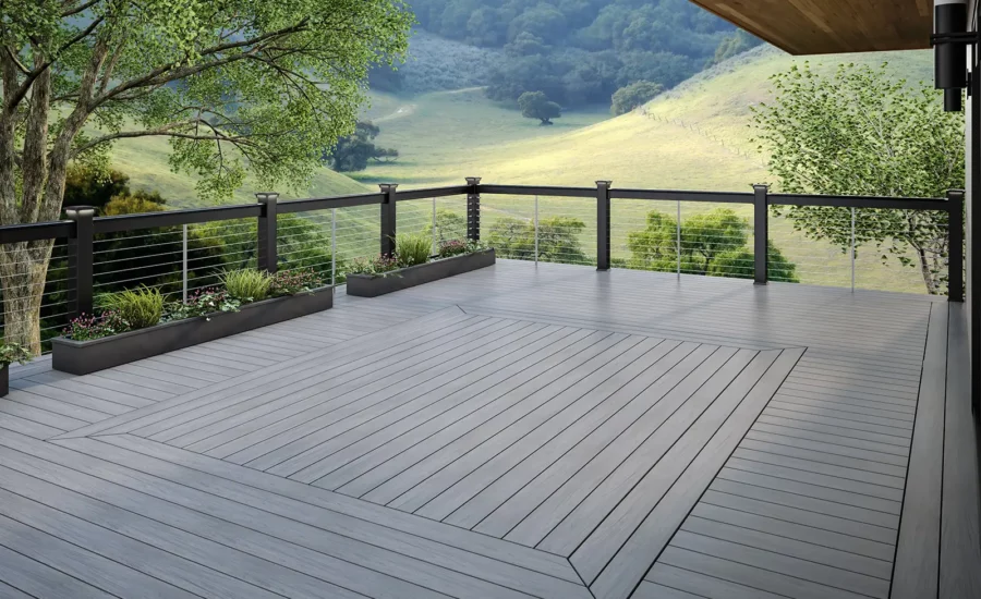 A mineral-based Composite deck by Deckorators. Vault product line with rolling hills and decking railing in the background