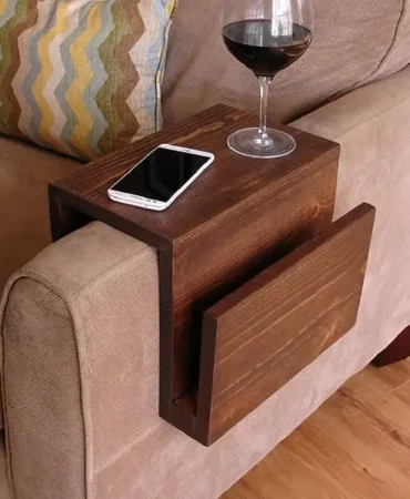 a wooden tray resting on a sofa arm