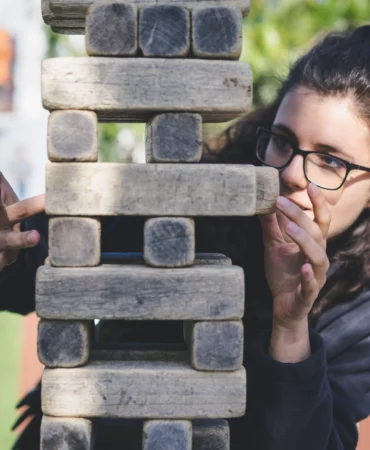 a woman playing with wooden blocks