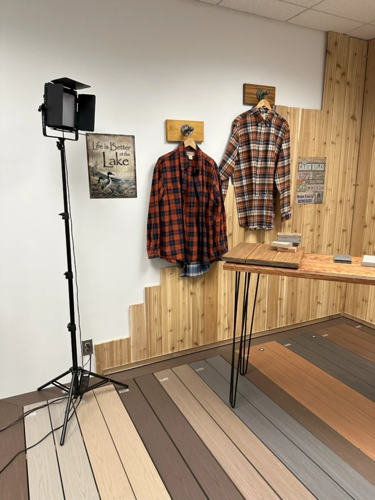 Two flannel shirts hanging on a wall.