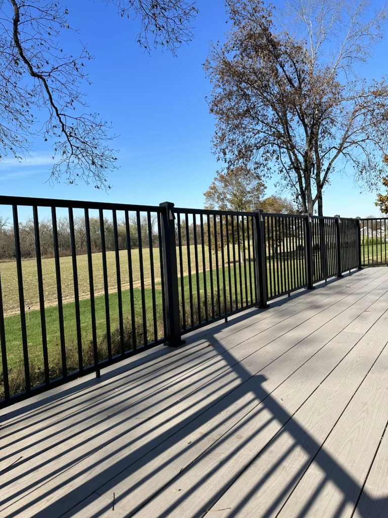 A sunny deck and railing.