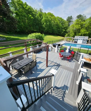 A gray Deckorators composite deck in the summertime.