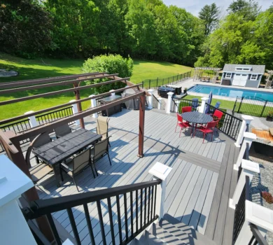 A gray Deckorators composite deck in the summertime.