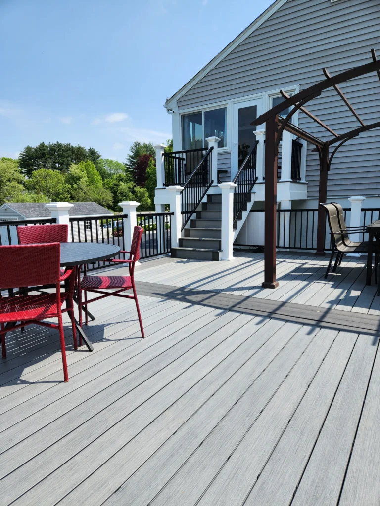 A gray Deckorators composite deck in the summertime from Warehouse 71.